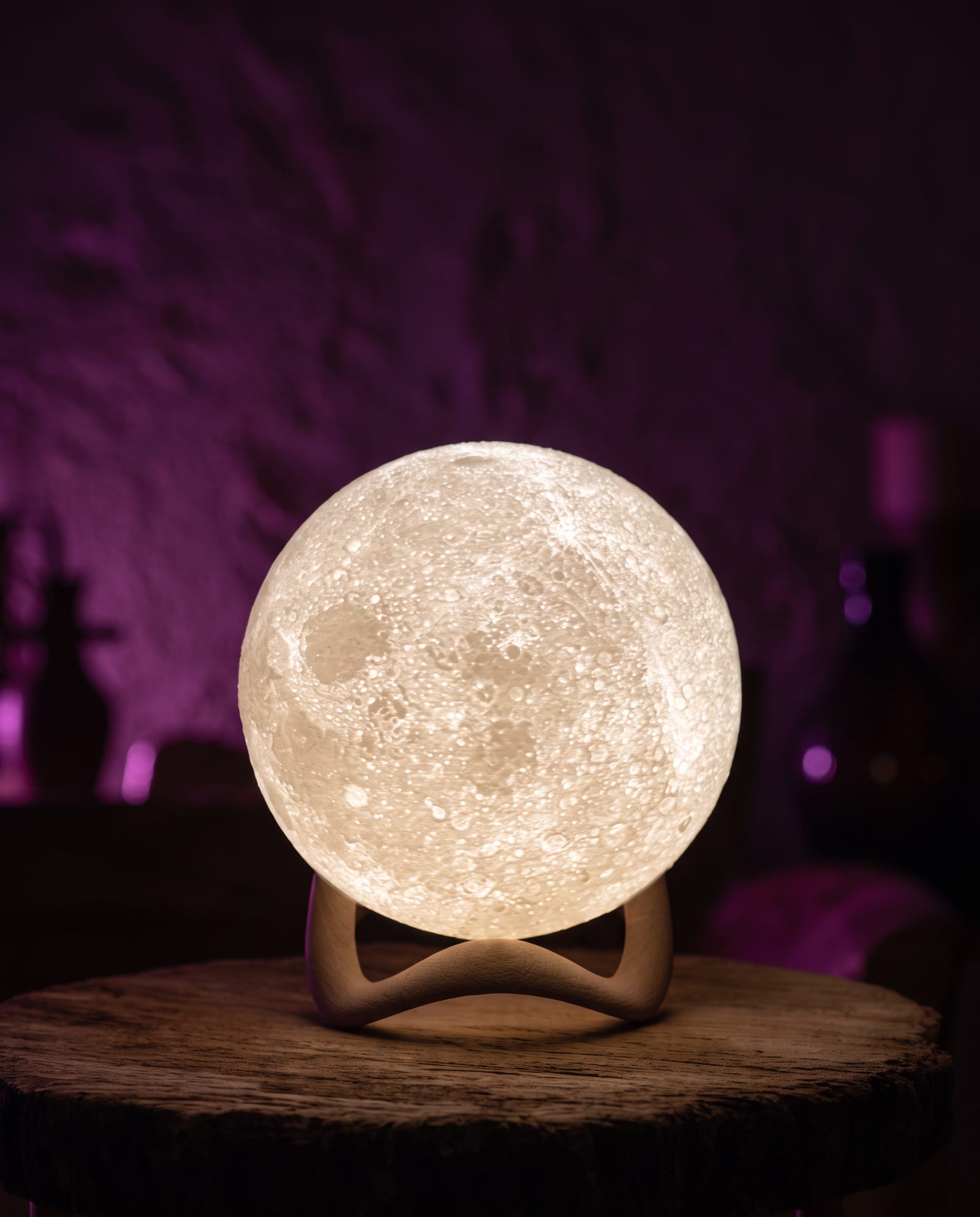 A moon lamp glowing in a dark room